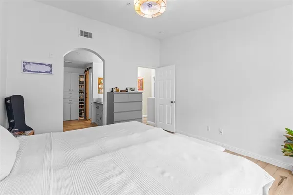 a bedroom with a bed and a television