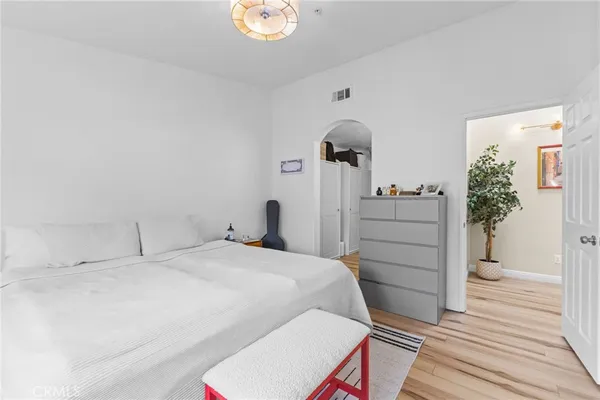 a bedroom with a bed and a dresser