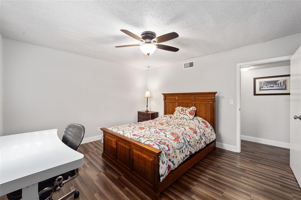 6519 West Newberry Road, Unit 1210 Gainesville, FL 32605 - Photo 13 of 16 a bedroom with a bed and a chandelier