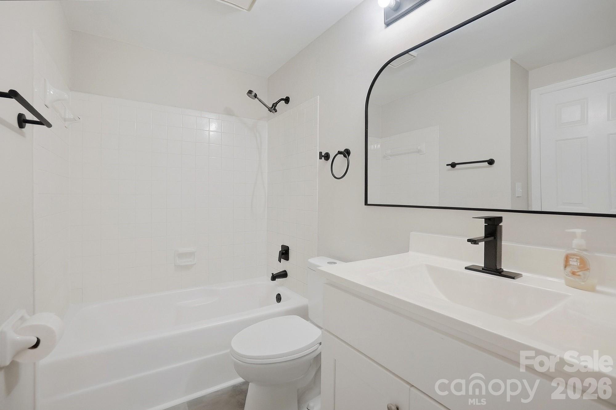 6621 Piney Path Road Charlotte, NC 28212 - Photo 13 of 36 a bathroom with a sink toilet and shower