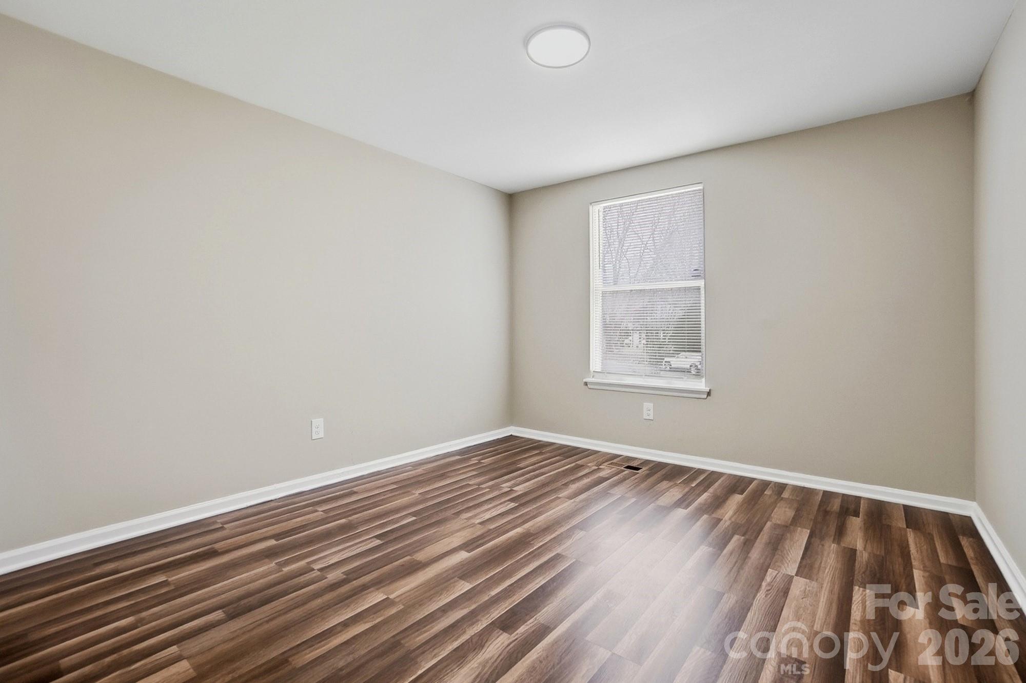 6621 Piney Path Road Charlotte, NC 28212 - Photo 15 of 36 wooden floor in an empty room with a window