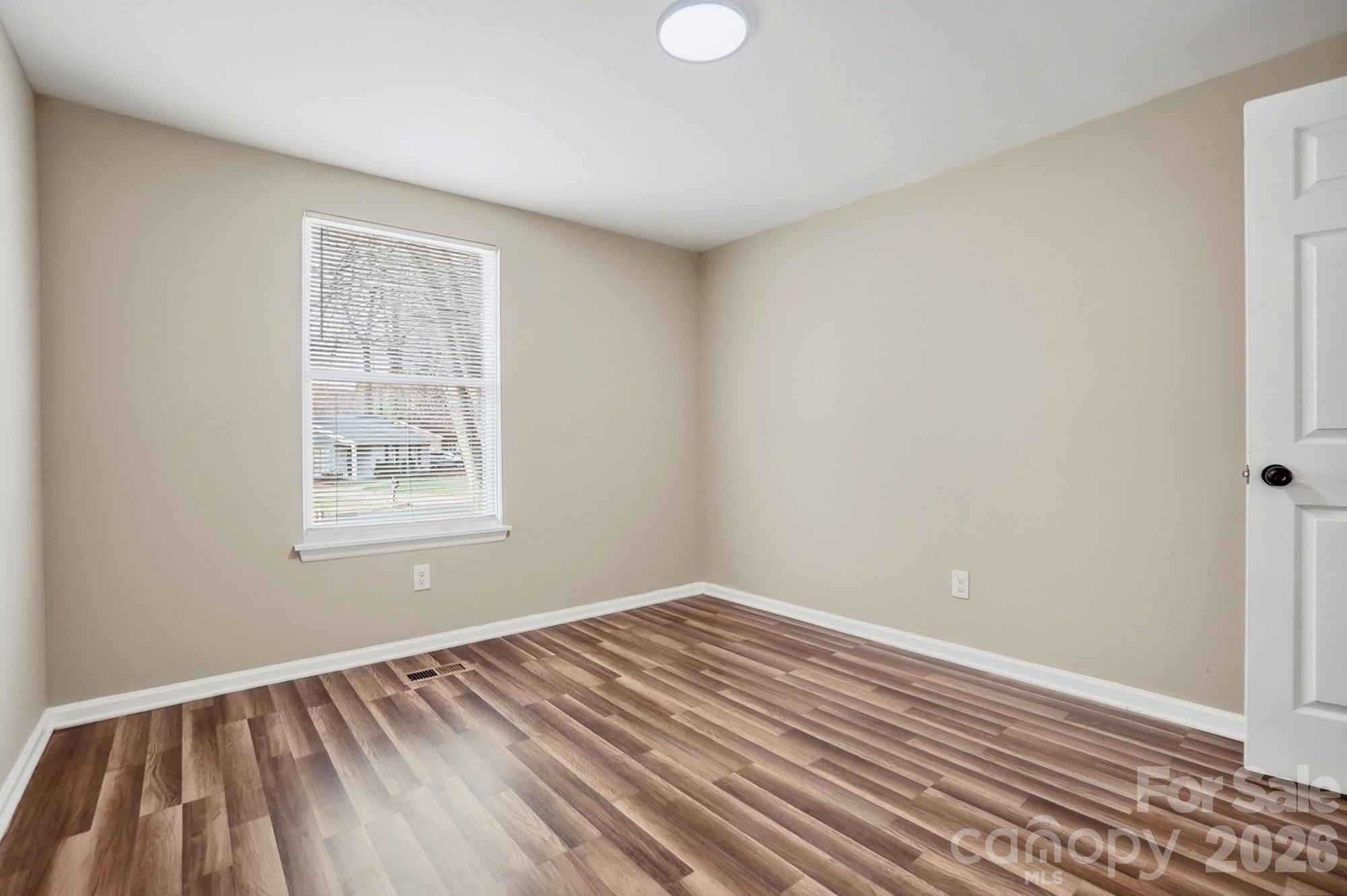 6621 Piney Path Road Charlotte, NC 28212 - Photo 16 of 36 wooden floor in an empty room with a window