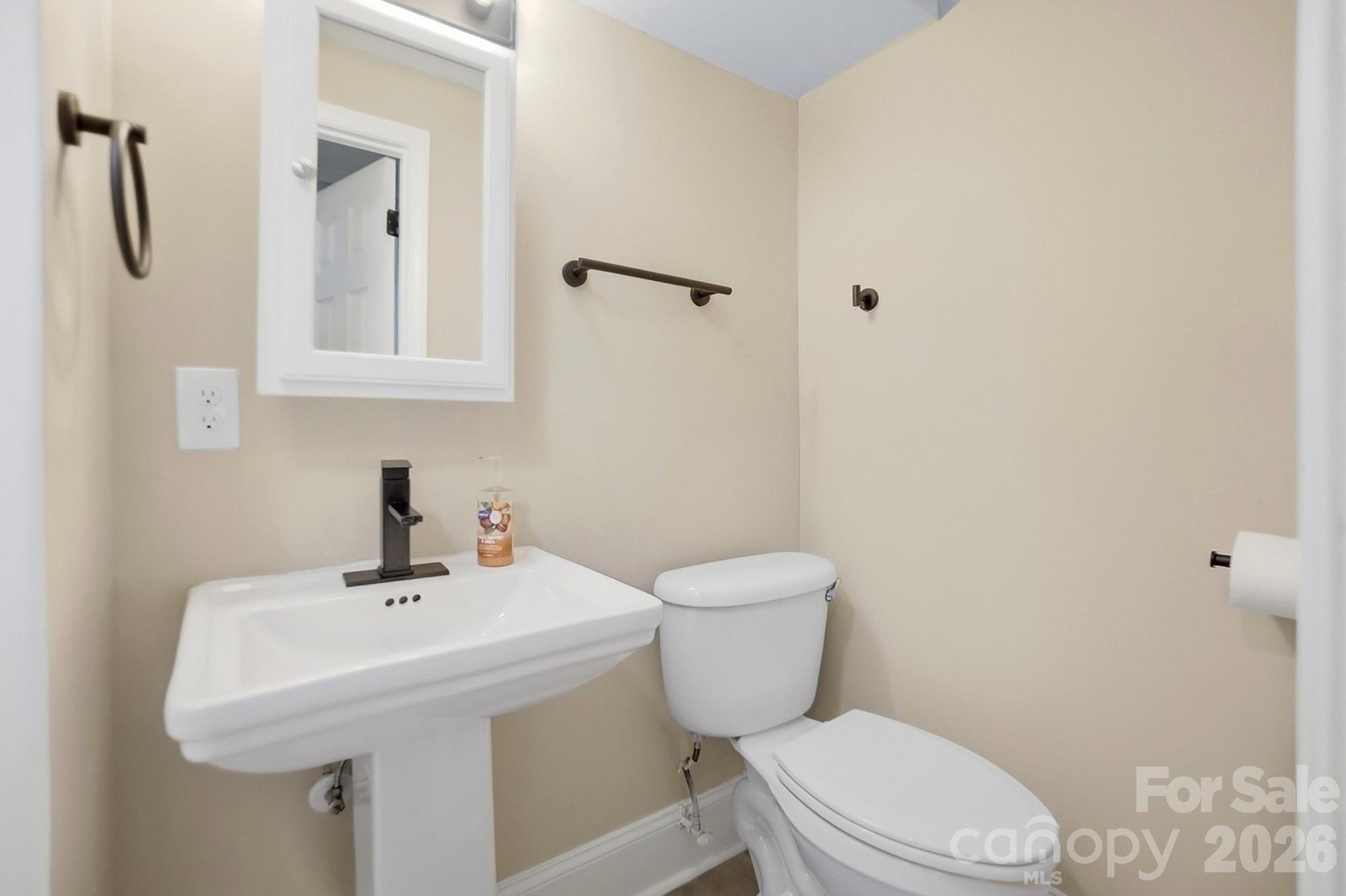 6621 Piney Path Road Charlotte, NC 28212 - Photo 23 of 36 a white toilet sitting next to a bathroom sink