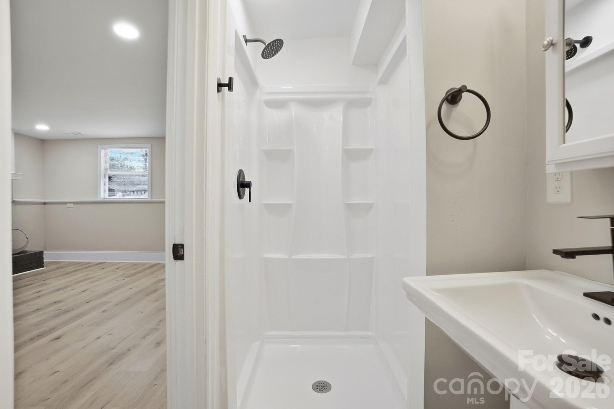 6621 Piney Path Road Charlotte, NC 28212 - Photo 24 of 36 a bathroom with a sink a toilet and shower