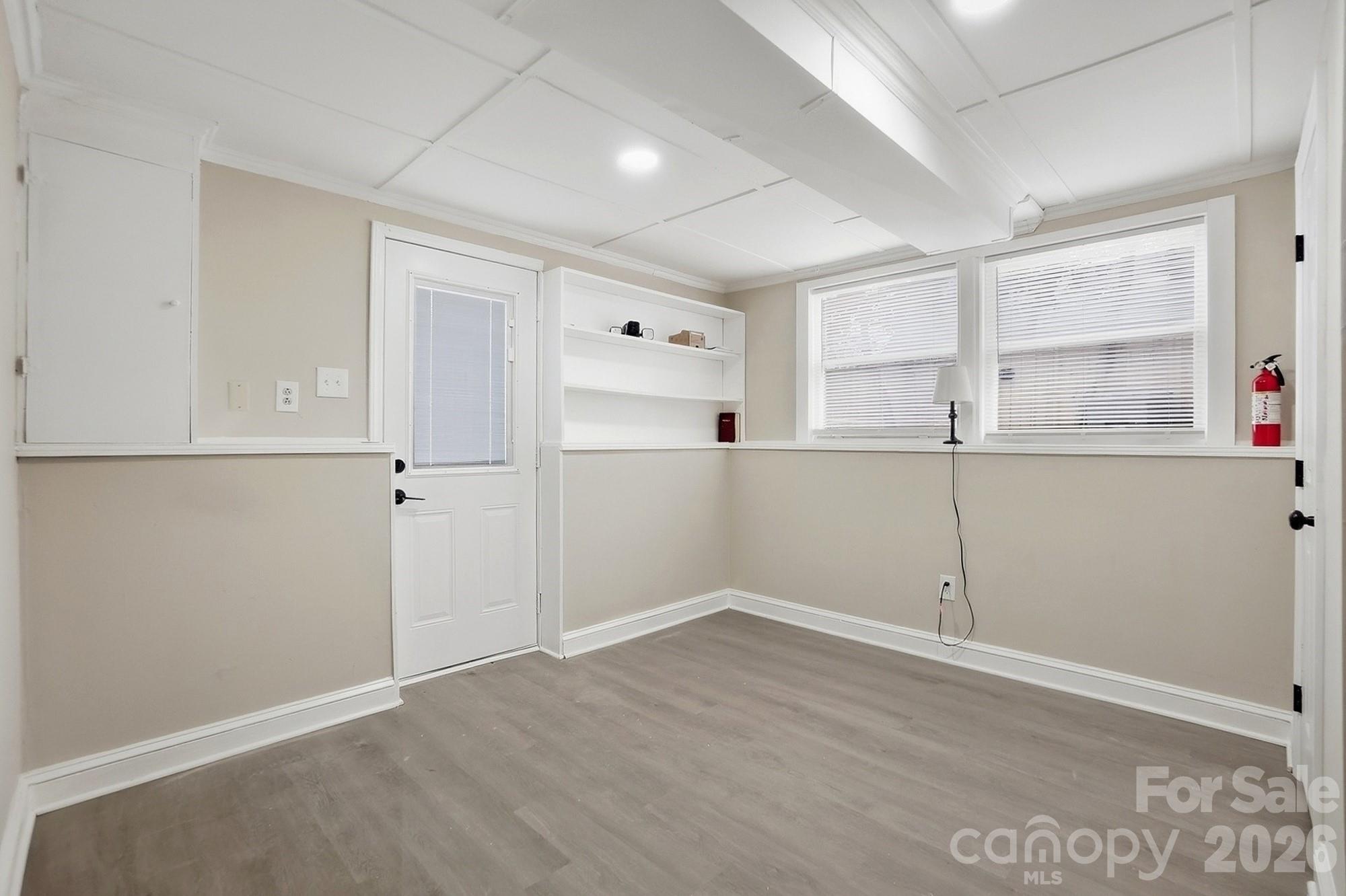 6621 Piney Path Road Charlotte, NC 28212 - Photo 27 of 36 an empty room with wooden floor and windows