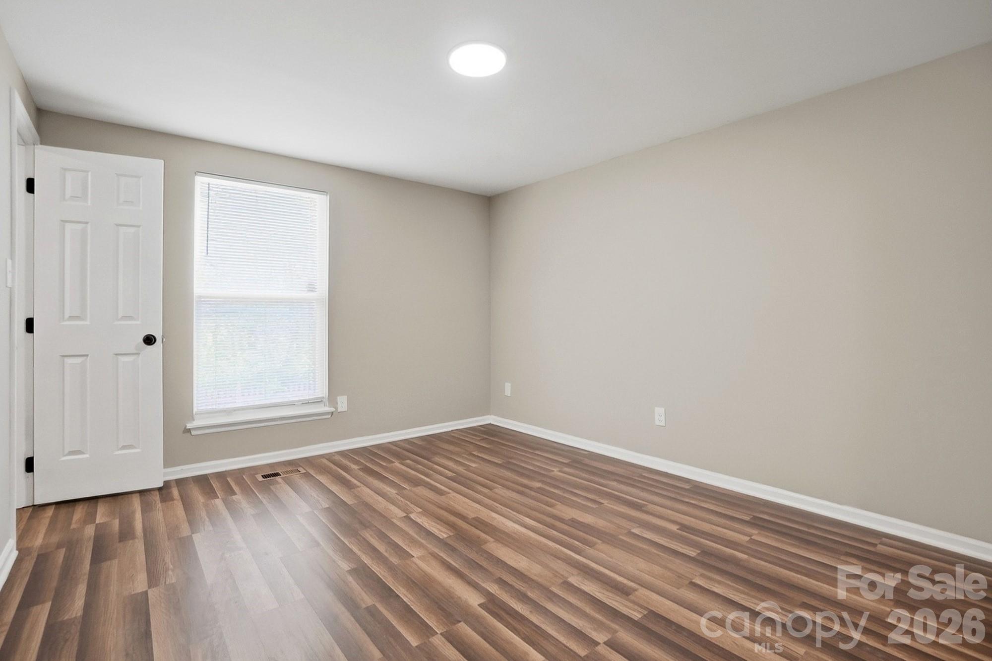 6621 Piney Path Road Charlotte, NC 28212 - Photo 9 of 36 a view of room with window and hardwood floor
