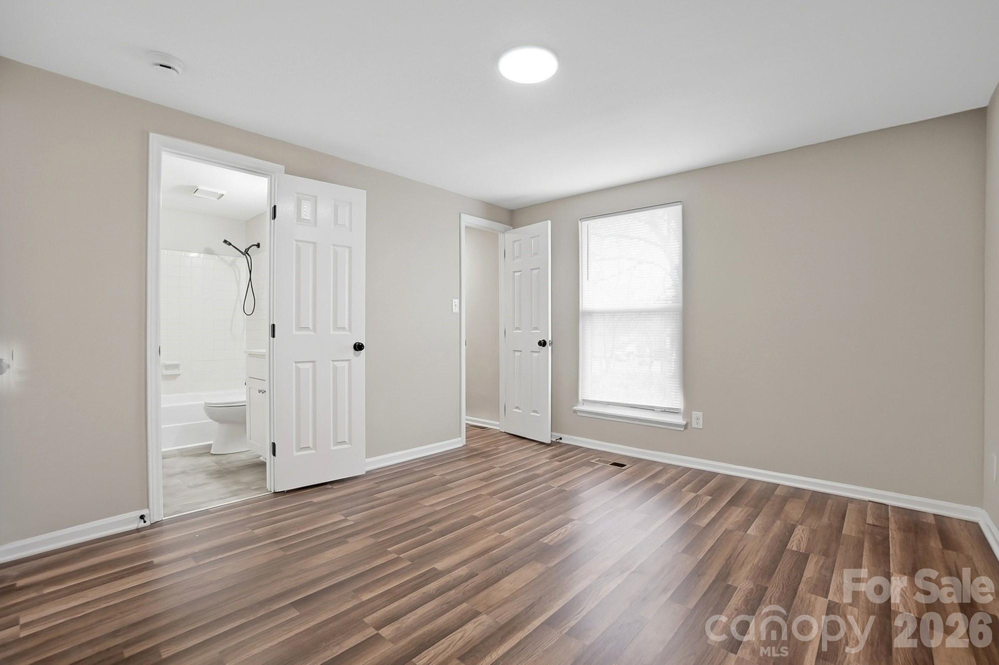6621 Piney Path Road Charlotte, NC 28212 - Photo 10 of 36 wooden floor in an empty room with a window