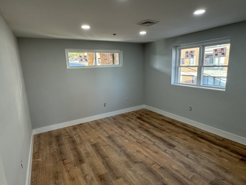 220 Broadway, Unit 2 Revere, MA 02151 - Photo 5 of 10 a view of an empty room with wooden floor and a window