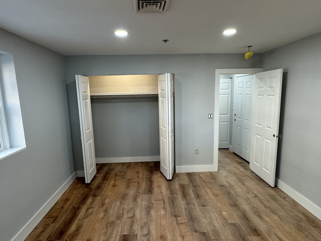 220 Broadway, Unit 2 Revere, MA 02151 - Photo 6 of 10 an empty room with wooden floor and entrance