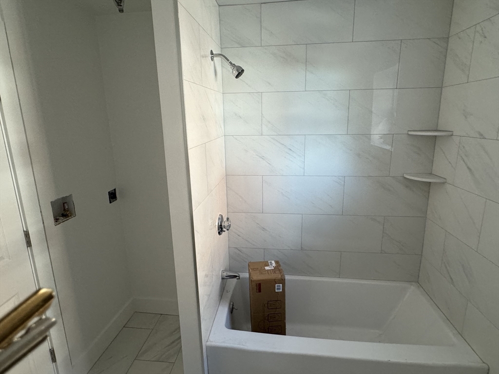 220 Broadway, Unit 2 Revere, MA 02151 - Photo 8 of 10 a bathroom with a bathtub