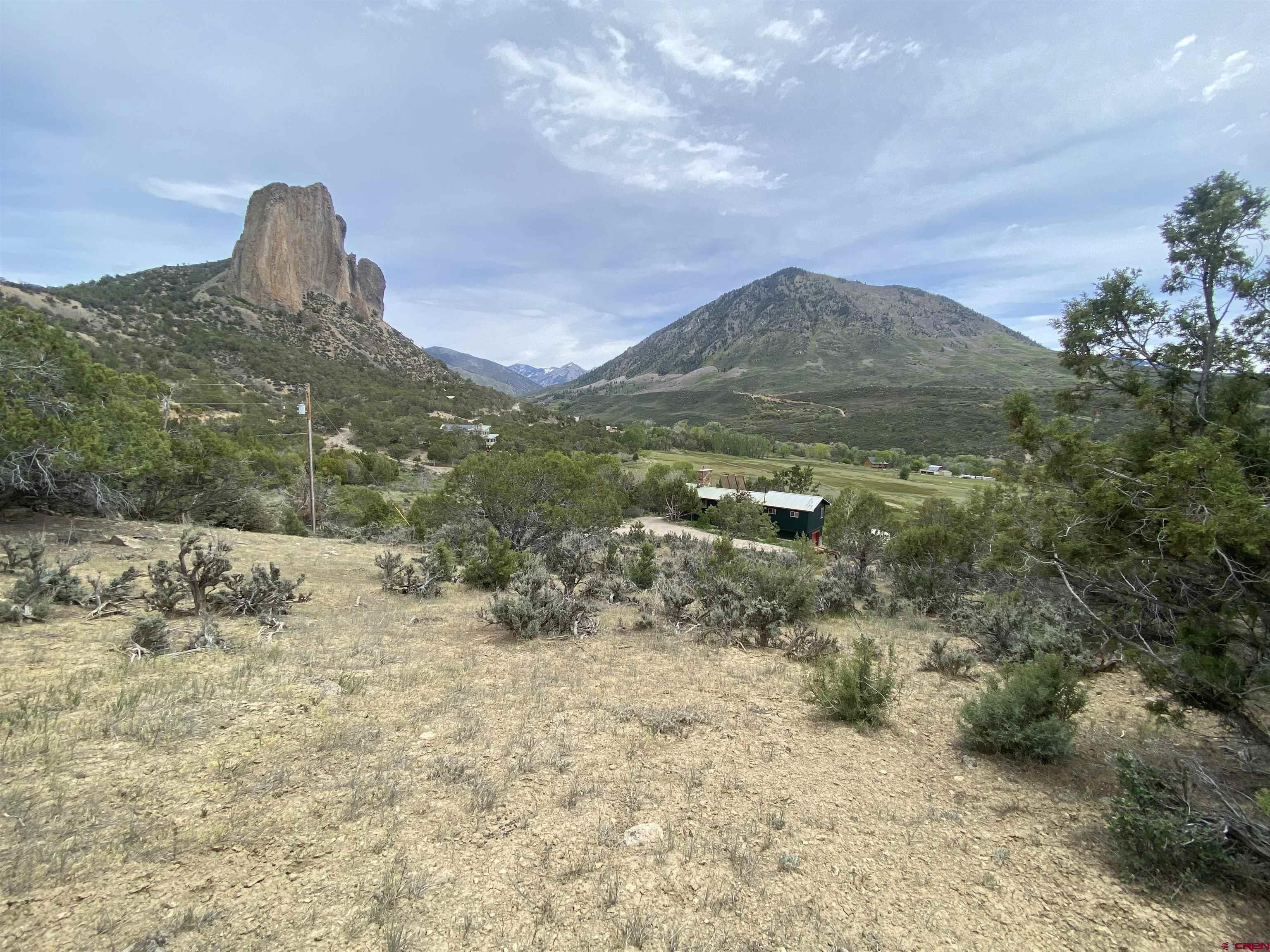 42996 Needle Rock Road Crawford, CO 81415 - Photo 38 of 45 a view of a dry yard with wooden fence and mountain view
