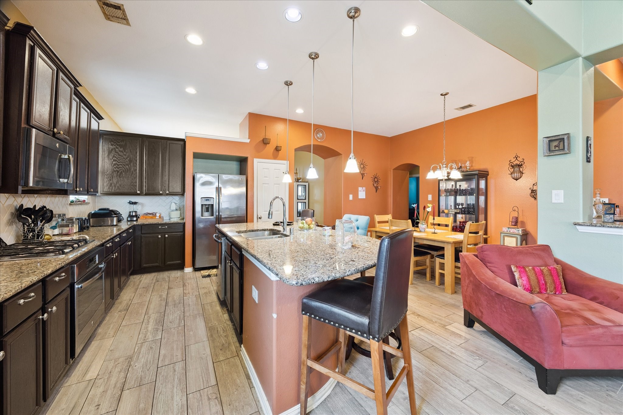 13117 Green Shores Lane Rosharon, TX 77583 - Photo 13 of 30 a kitchen with stainless steel appliances granite countertop sink stove top oven and cabinets