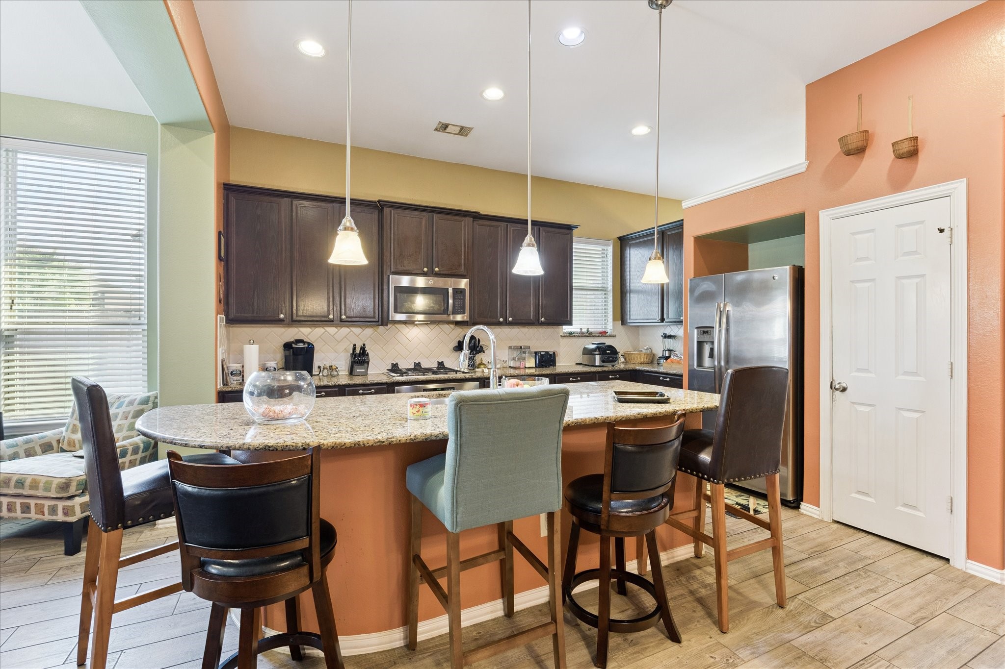 13117 Green Shores Lane Rosharon, TX 77583 - Photo 14 of 30 a kitchen with stainless steel appliances kitchen island granite countertop a table chairs and a refrigerator