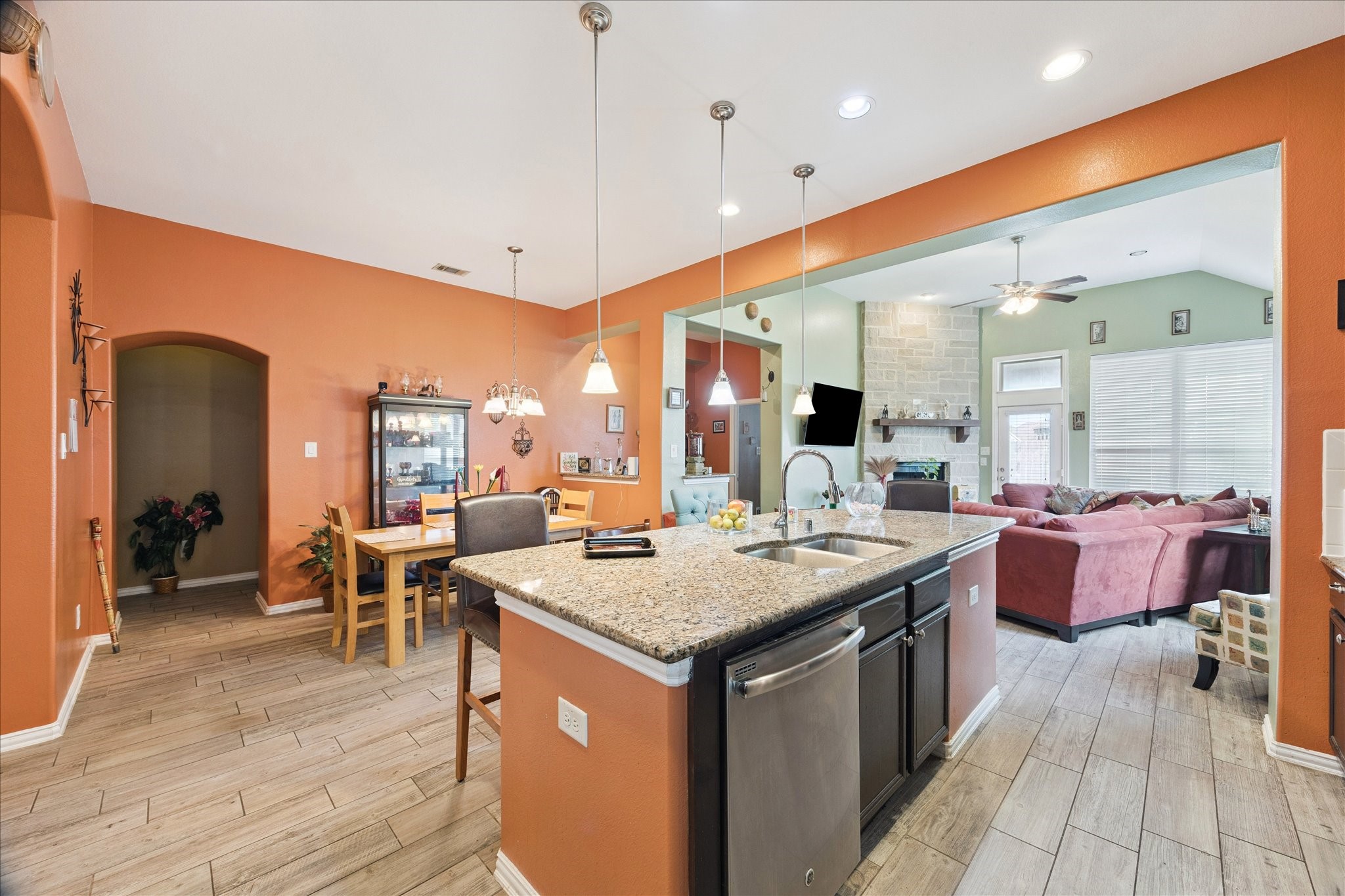 13117 Green Shores Lane Rosharon, TX 77583 - Photo 16 of 30 a open kitchen with stainless steel appliances granite countertop a stove top oven a dining table and chairs with wooden floor