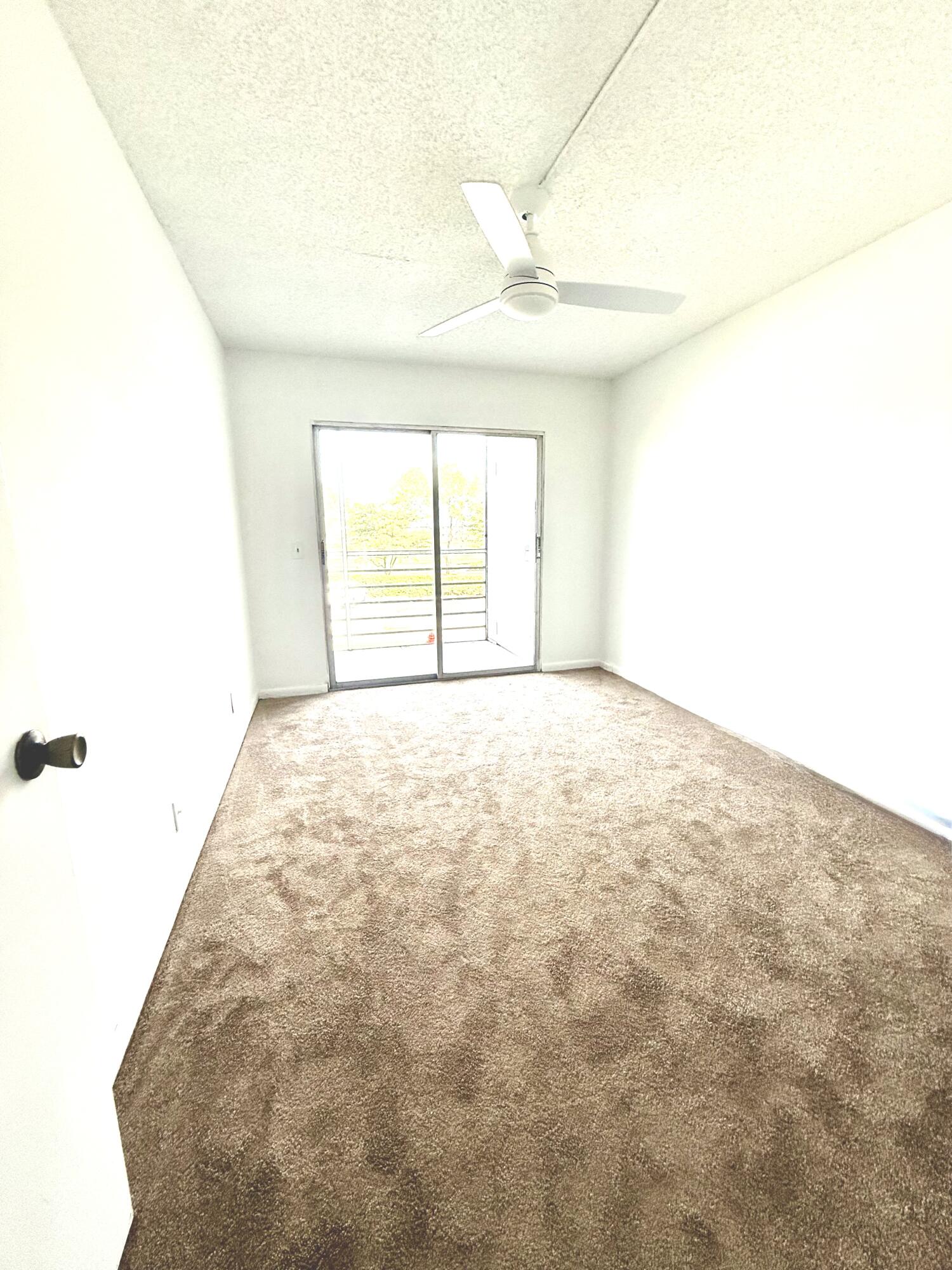402 Brighton J, Unit J Boca Raton, FL 33434 - Photo 12 of 21 a view of an empty room with a window