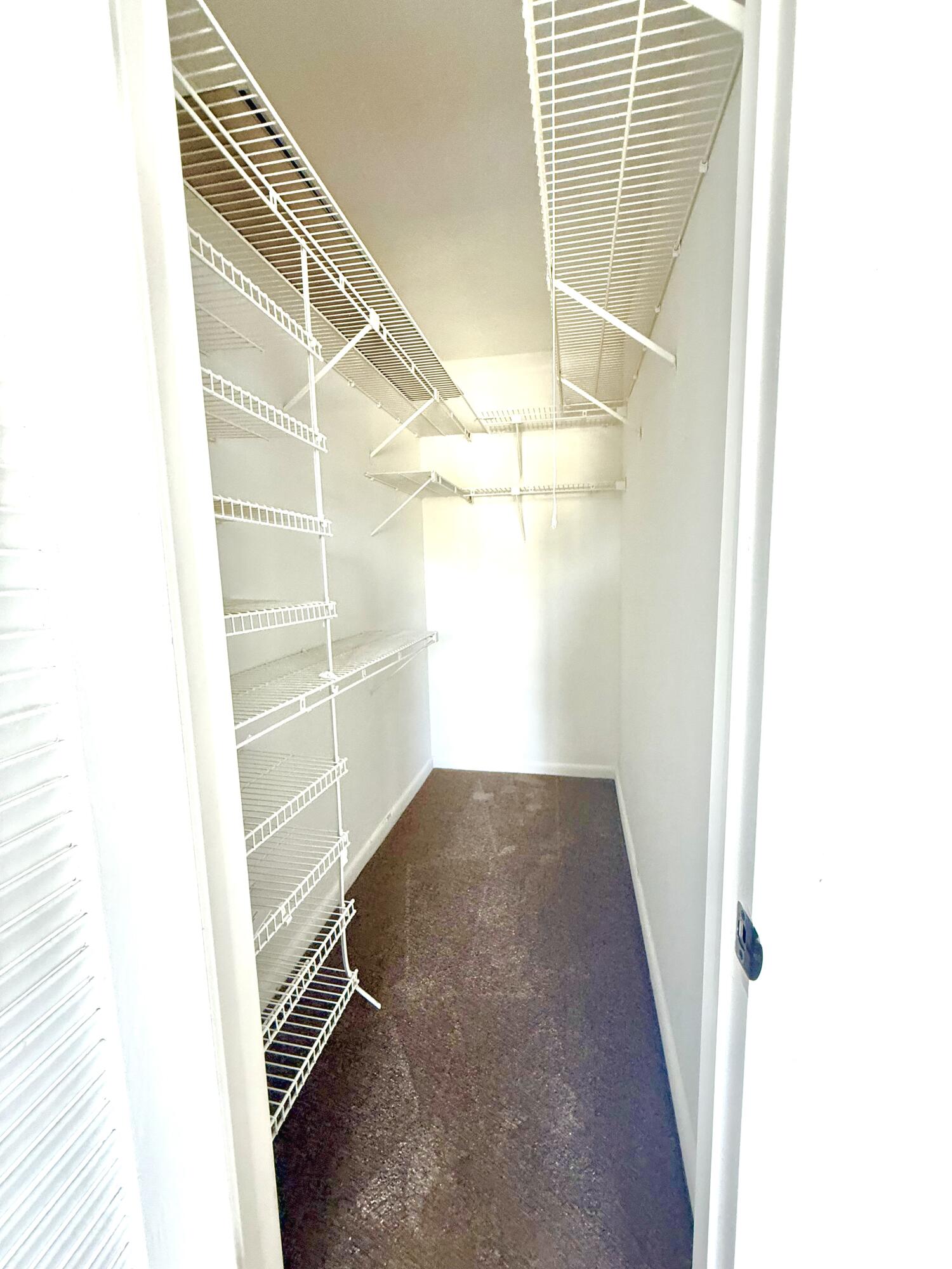 402 Brighton J, Unit J Boca Raton, FL 33434 - Photo 13 of 21 a view of a room with racks on the wall