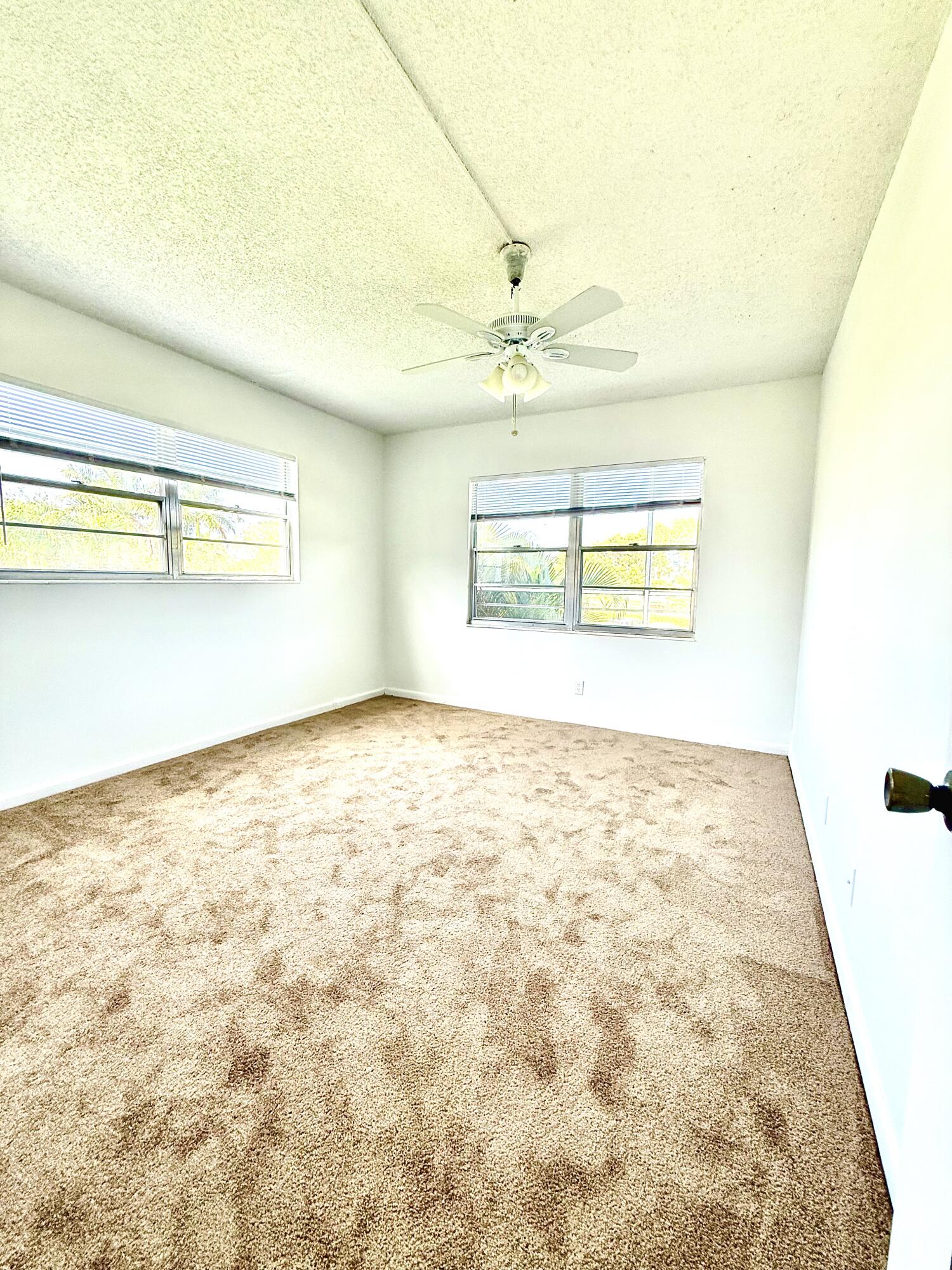 402 Brighton J, Unit J Boca Raton, FL 33434 - Photo 16 of 21 a view of an empty room and window