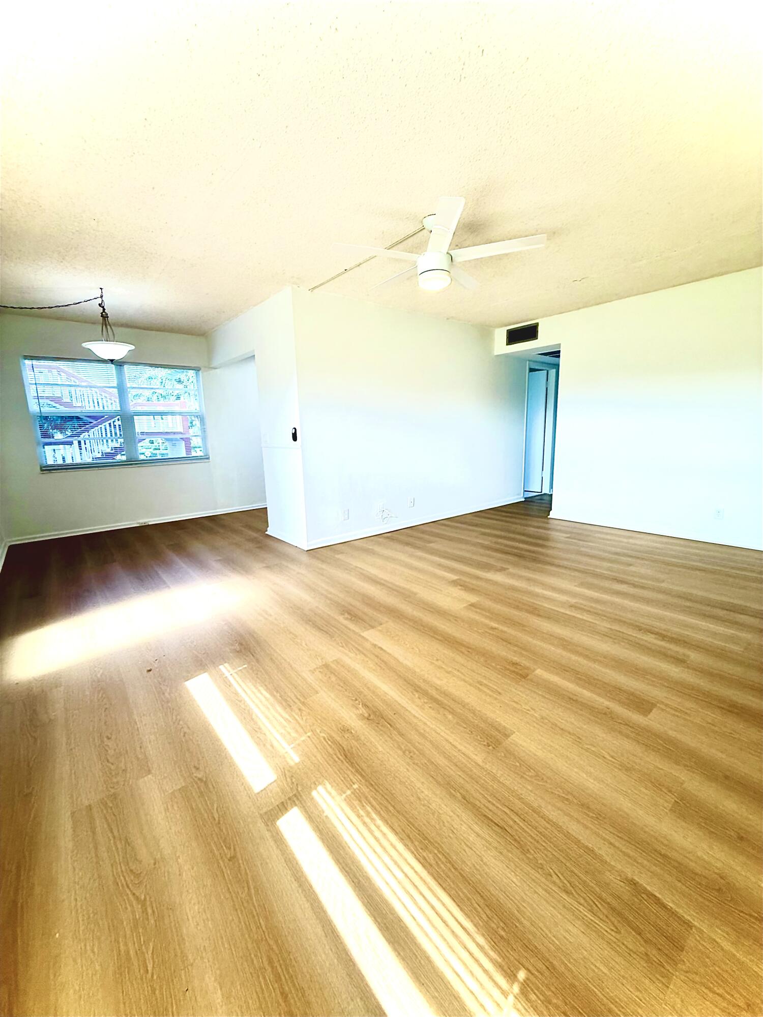 402 Brighton J, Unit J Boca Raton, FL 33434 - Photo 10 of 21 a view of a room with gym equipment and a window