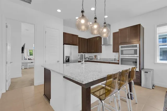 a kitchen with granite countertop a sink and cabinets