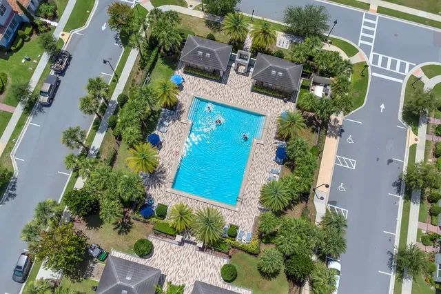 an aerial view of residential houses with outdoor space and city view