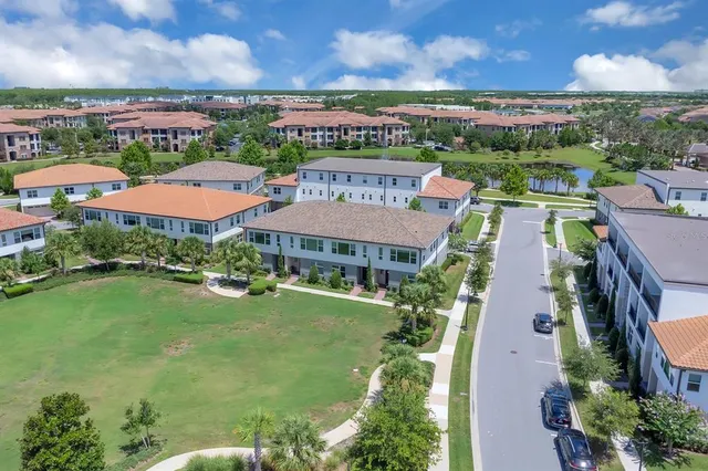 an aerial view of a houses with a lake view