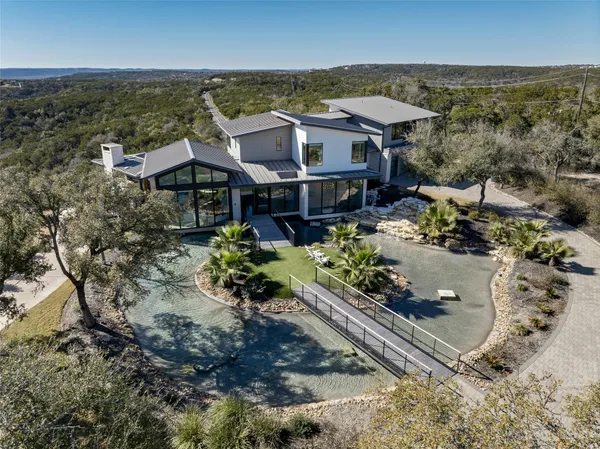 an aerial view of a house with a yard