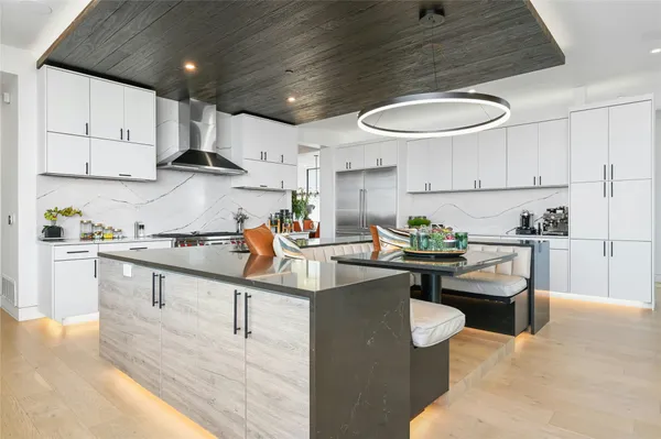 a kitchen with stainless steel appliances kitchen island granite countertop a sink and cabinets