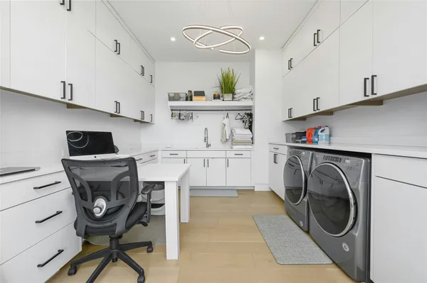 a utility room with cabinets dryer and washer