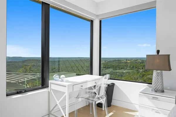 a view of balcony with a table and chairs
