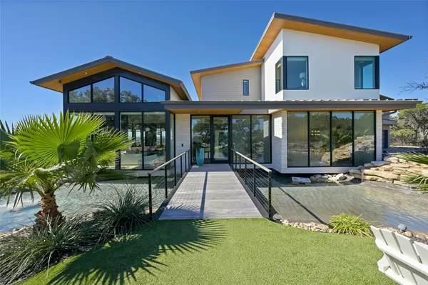 a view of house with a swimming pool and glass windows