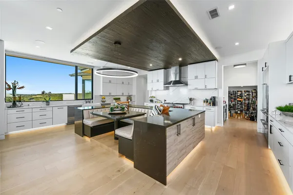 a kitchen with counter top space a sink and appliances