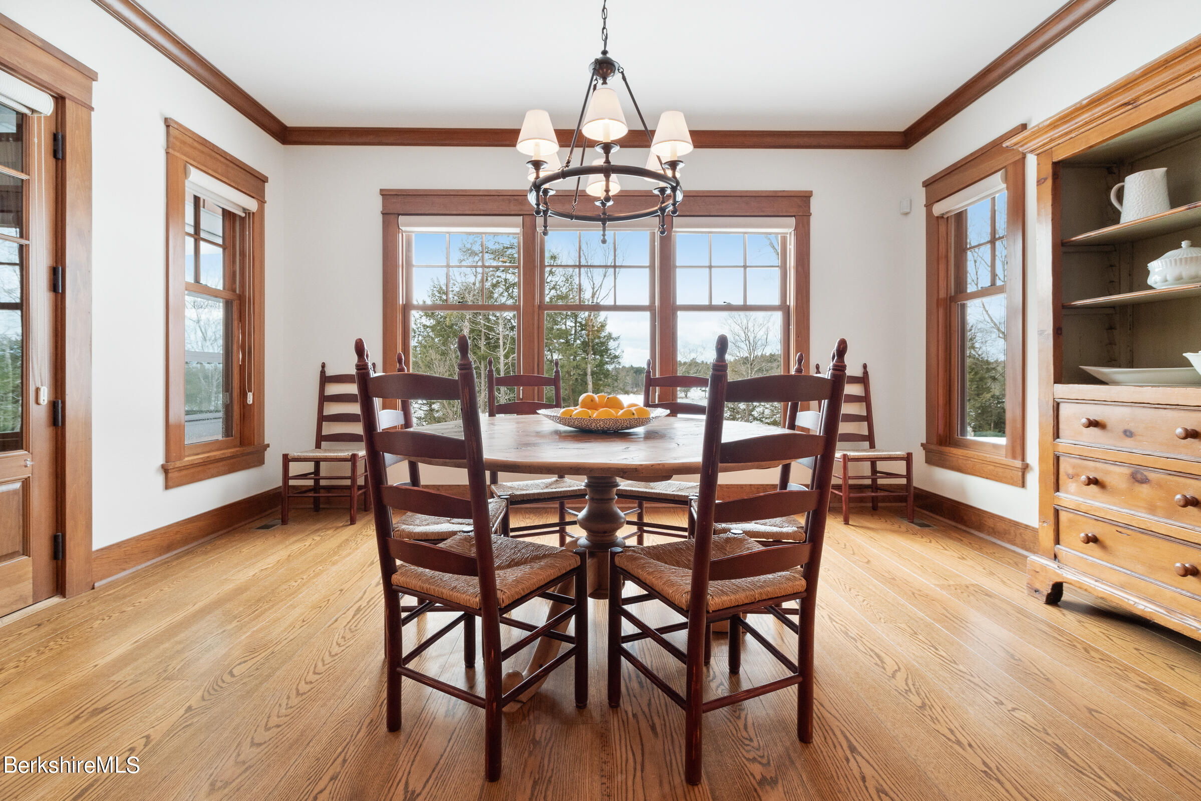 707 Stratford Road New Marlborough, MA 01259 - Photo 23 of 72 a dining room with furniture large windows and wooden floor