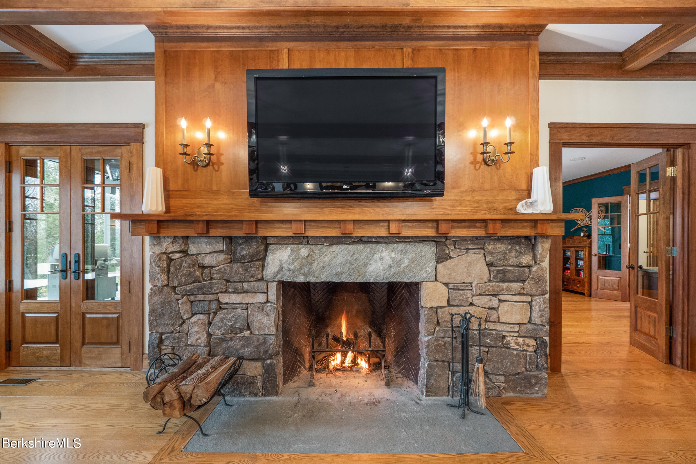707 Stratford Road New Marlborough, MA 01259 - Photo 27 of 72 a living room with a fireplace a flat screen tv and outdoor view