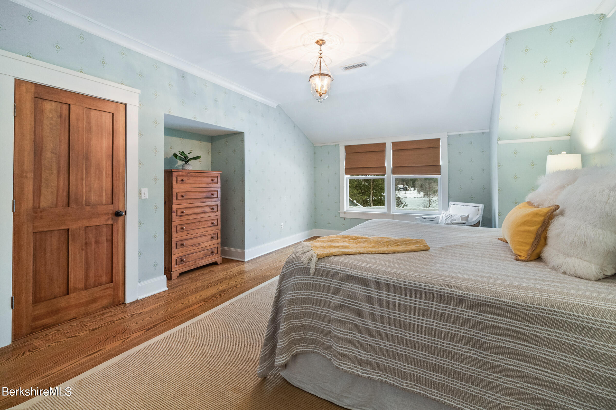 707 Stratford Road New Marlborough, MA 01259 - Photo 49 of 72 a bedroom with a bed and dresser with wooden floor