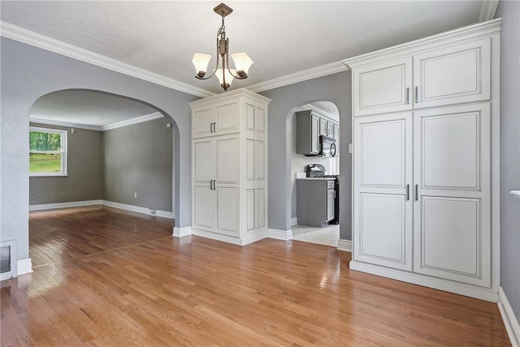 809 Franklin Road Mars, PA 16046 - Photo 13 of 44 Dining area with chandelier, built-ins, and arched entry