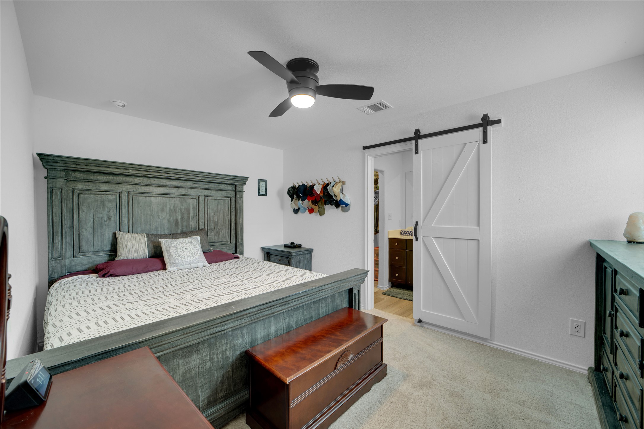 36 Trinity Circle Lockhart, TX 78644 - Photo 27 of 36 a bedroom with a bed and a refrigerator