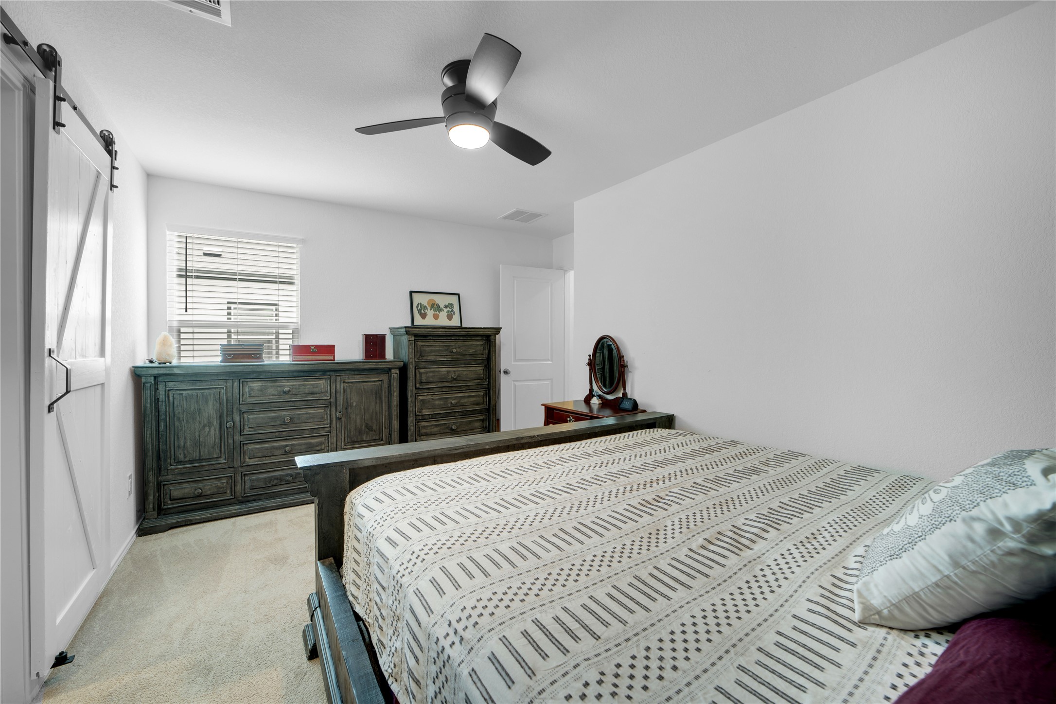 36 Trinity Circle Lockhart, TX 78644 - Photo 28 of 36 a bedroom with a bed and a chandelier
