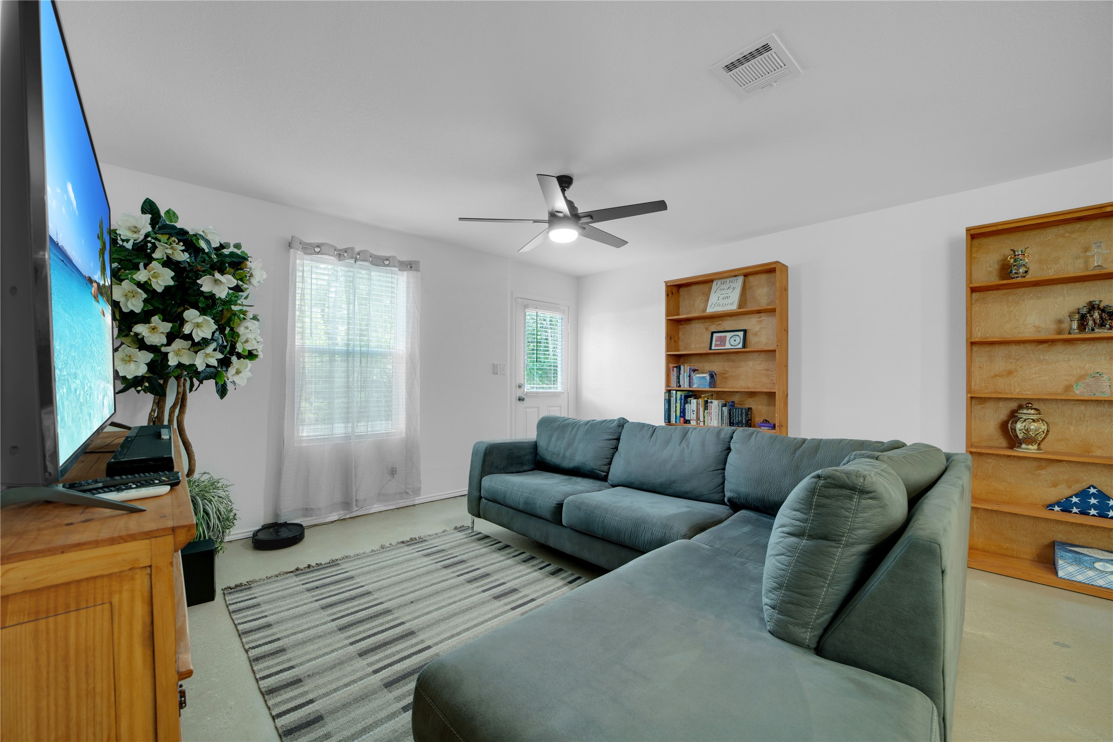 36 Trinity Circle Lockhart, TX 78644 - Photo 4 of 36 a living room with furniture a window and a chandelier