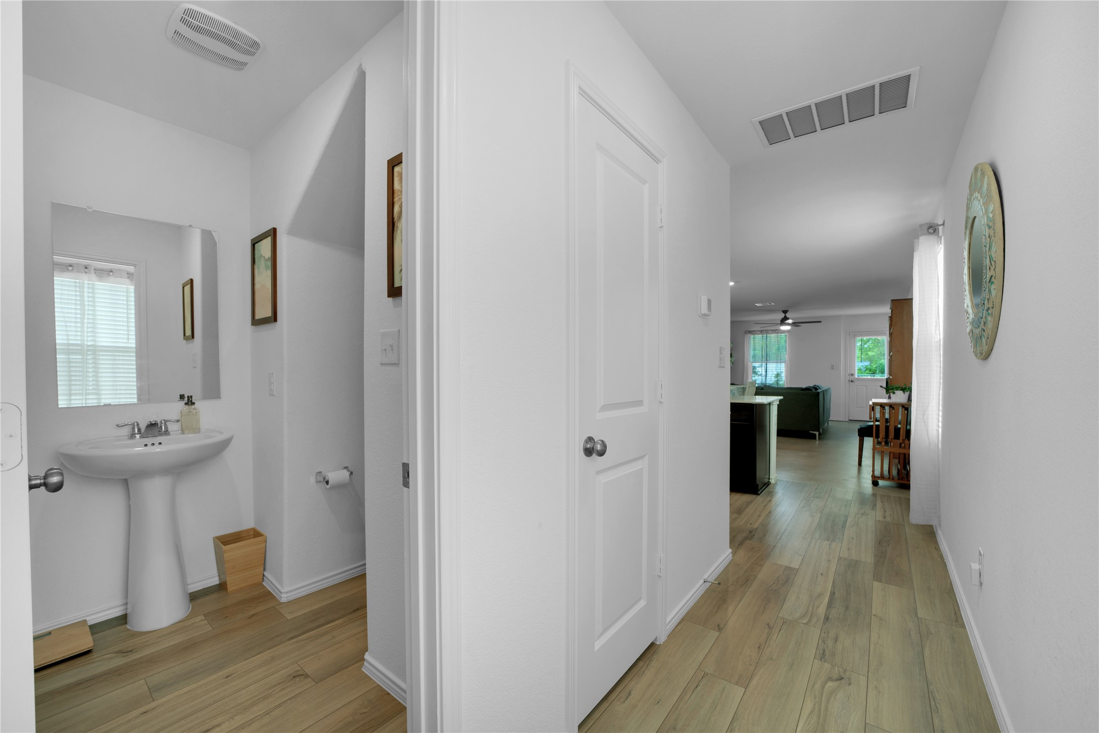 36 Trinity Circle Lockhart, TX 78644 - Photo 9 of 36 a view of a hallway with wooden floor windows and a bathroom