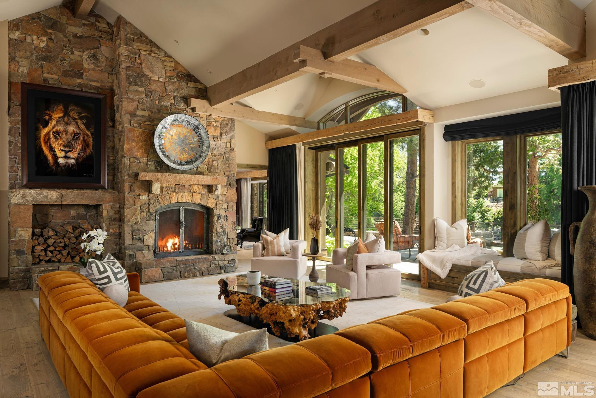 a living room with furniture a fireplace and a large window