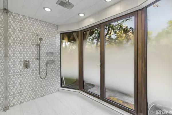 a bathroom with a glass shower door