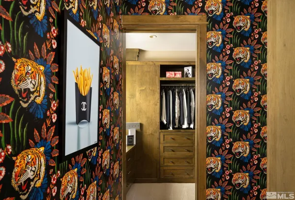 a living room with furniture a bookshelf and a large window