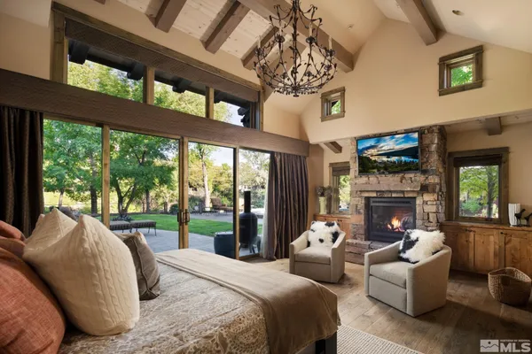 a spacious bedroom with a bed and a chandelier