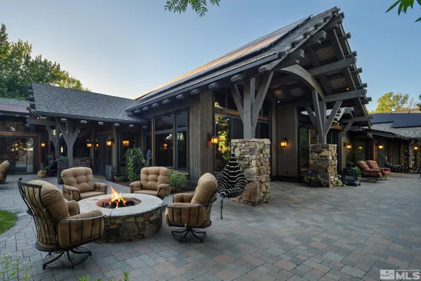 a view of a patio with couches chairs and a fire pit
