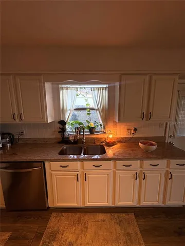 a kitchen with stainless steel appliances granite countertop a sink stove and cabinets