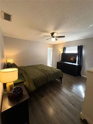 a bedroom with a bed and a lamp