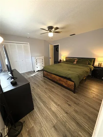 a bedroom with double bed and a desk