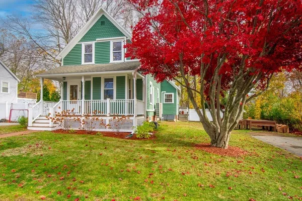 a front view of a house with yard and green space