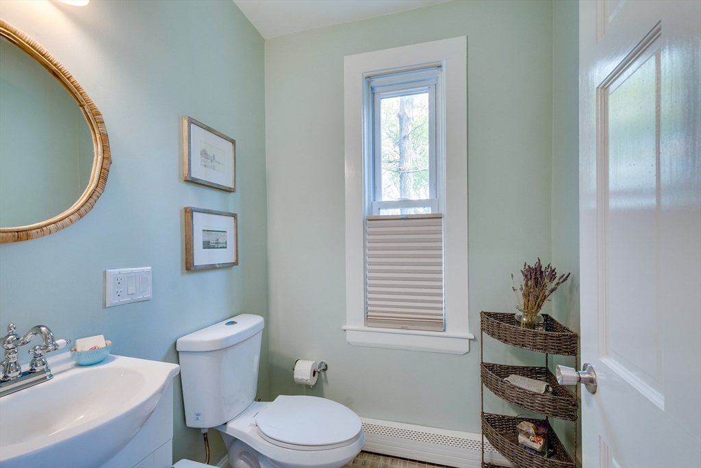 10 Eaton Street Reading, MA 01867 - Photo 11 of 15 a white toilet sitting next to a bathroom sink
