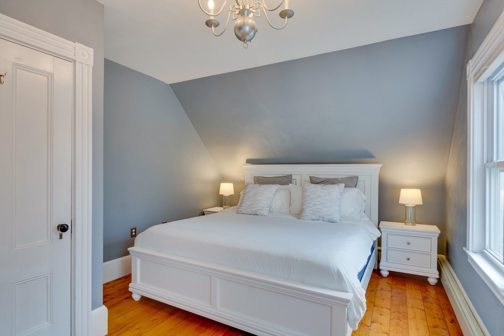 10 Eaton Street Reading, MA 01867 - Photo 13 of 15 a bedroom with a bed and wooden floor